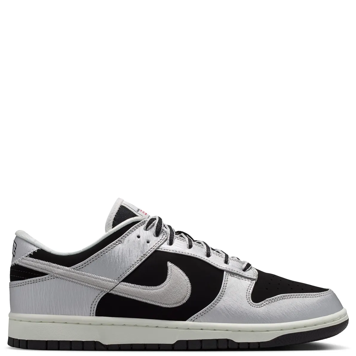Medial side profile of Nike Dunk Low Retro with metallic overlays and black base.