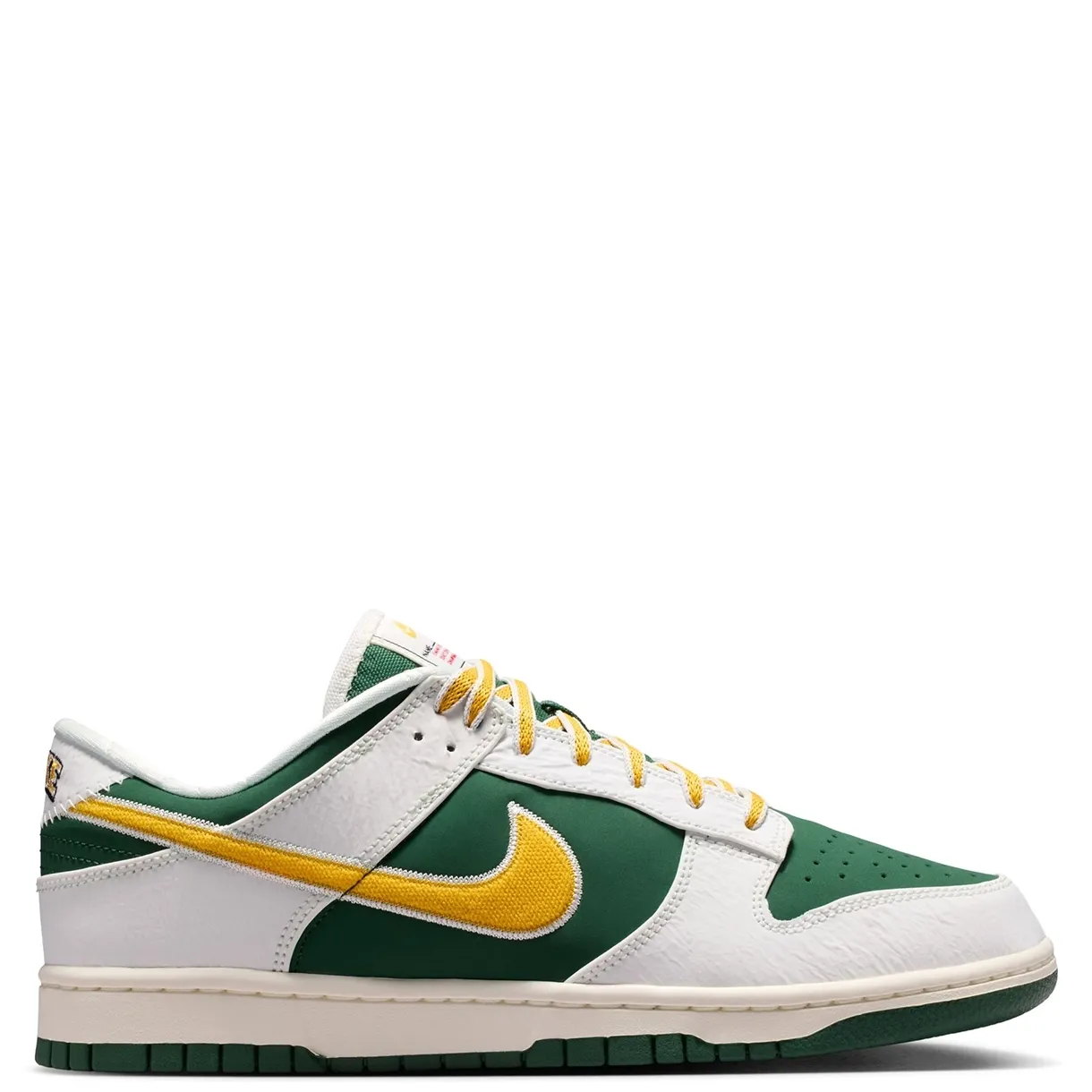 Medial side profile of Nike Dunk Low Retro with embroidered gold Swoosh