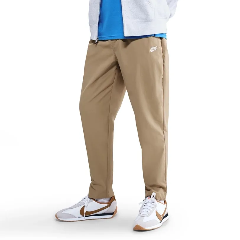 Front angled view of Nike Club Woven Taper Pants in Parachute Beige