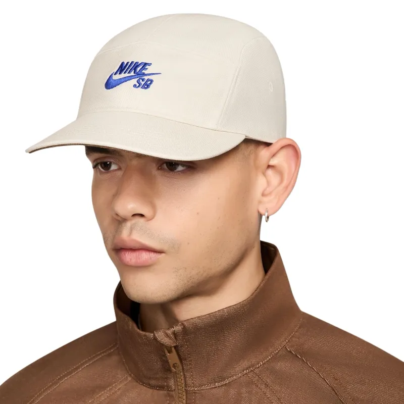 Front angle of Nike SB Fly Unstructured Hat in Light Orewood Brown with blue embroidered logo