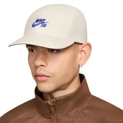 Front angle of Nike SB Fly Unstructured Hat in Light Orewood Brown with blue embroidered logo