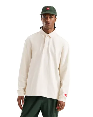 Front view of The North Face Red Box Rugby Shirt in White Dune with oversized fit, collar and hidden quarter placket.