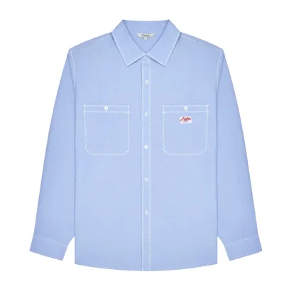 Front flat lay of the Malbon Golf Benchmark Shirt in Blue Chambray with button-front and oversized chest pockets.