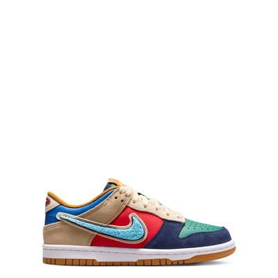 Medial side profile of Nike Dunk Low GS with blue chenille Swoosh and colorful leather panels.