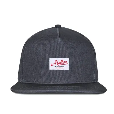 Front view of the Malbon Golf Benchmark Snapback Hat showcasing the woven heritage logo patch.