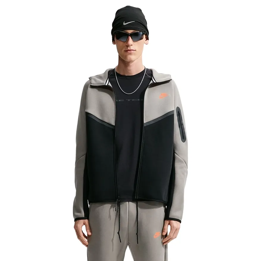 Front view of the open Nike Tech Fleece Windrunner showing Light Army panels, black body and sleeve pocket.