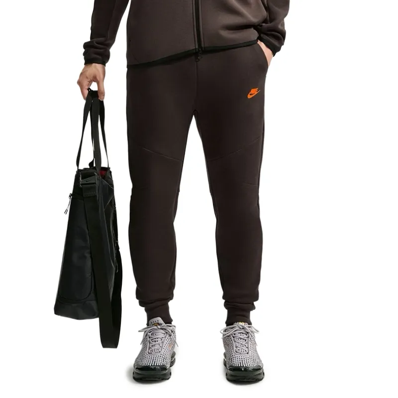 Front view of Velvet Brown Nike Tech Fleece Joggers showing articulated seams and Crimson Futura branding.