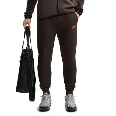 Front view of Velvet Brown Nike Tech Fleece Joggers showing articulated seams and Crimson Futura branding.