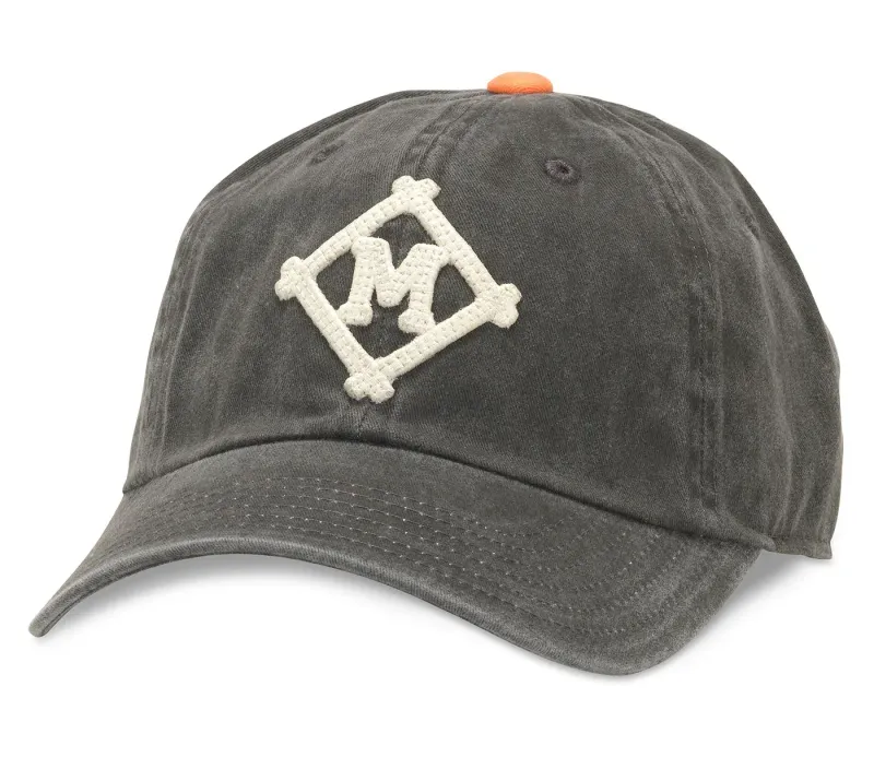 Front view of washed black Minneapolis Millers Archive hat with cream logo embroidery and orange top button.