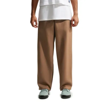 Front view of Nike SB Albatross pants in Mosswood Brown showing the relaxed silhouette and straight legs.