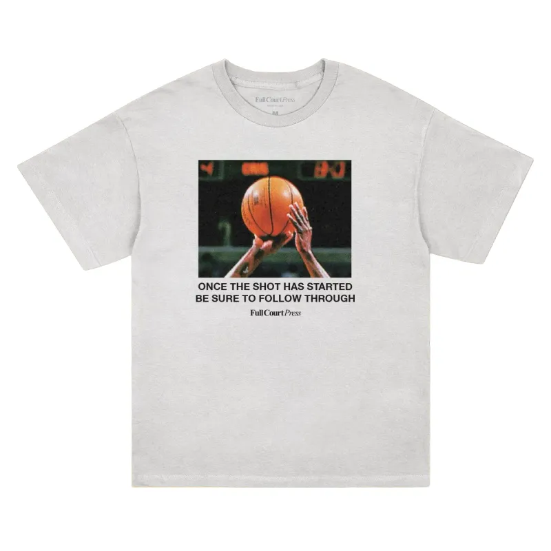 White Full Court Press Follow Through tee with a basketball shooting photo and bold instructional text on the front.