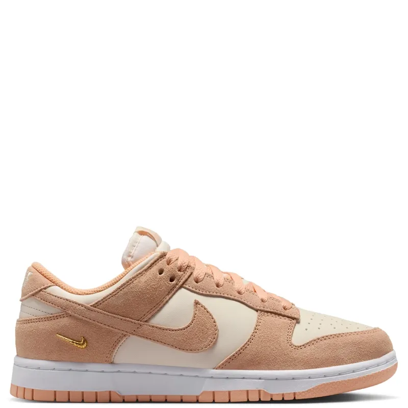 Medial view of Nike Women's Dunk Low Suede showing suede overlays, Chalk panels and metallic gold mini Swoosh.