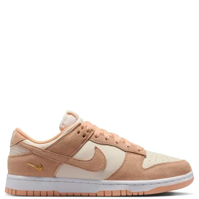Medial view of Nike Women's Dunk Low Suede showing suede overlays, Chalk panels and metallic gold mini Swoosh.