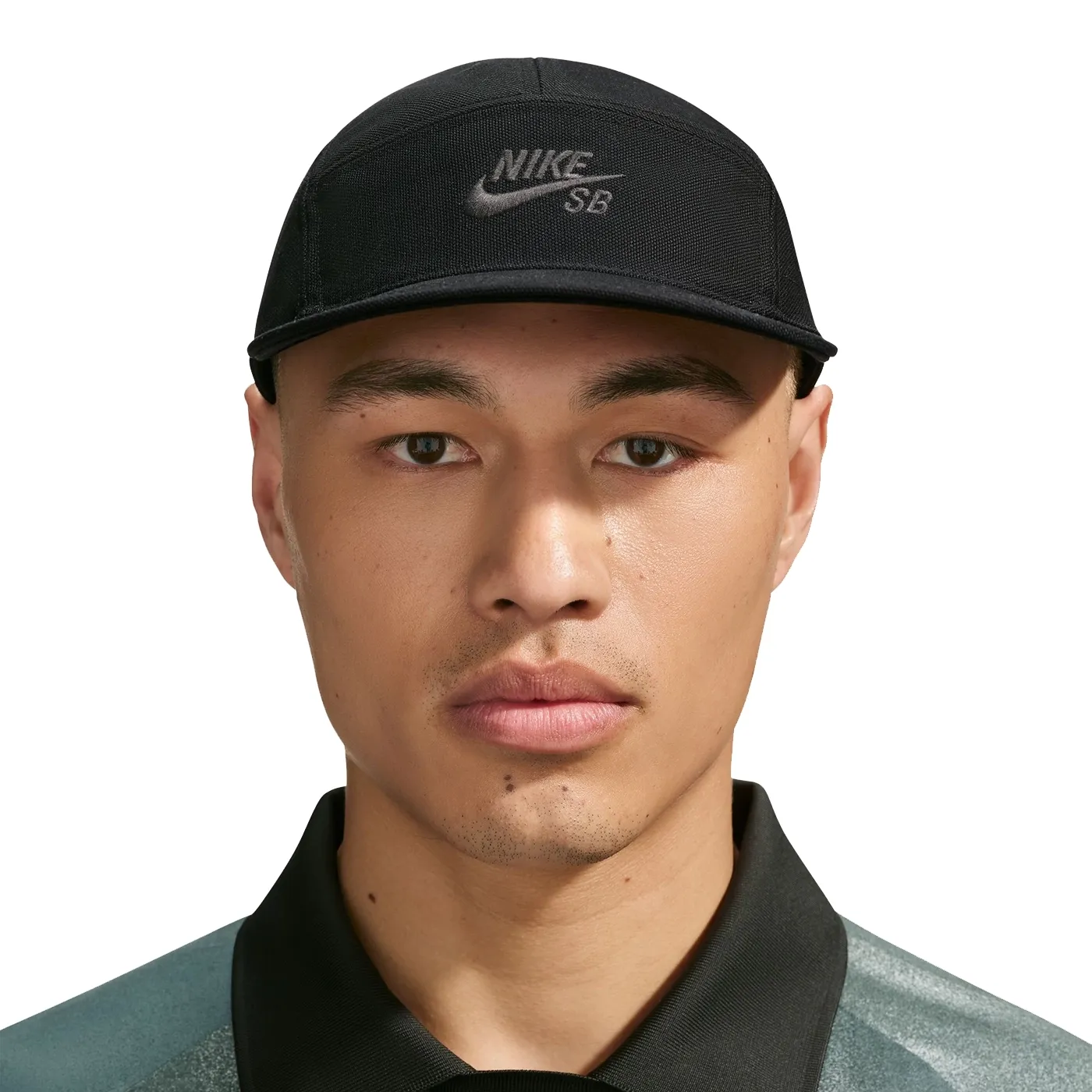 Front view of a model wearing the black Nike SB Fly cap with a low crown and tonal embroidered Nike SB logo.