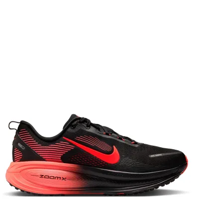 Lateral profile of the Nike Vomero 18 showing red graphics, a crimson Swoosh and ZoomX-branded cushioning.