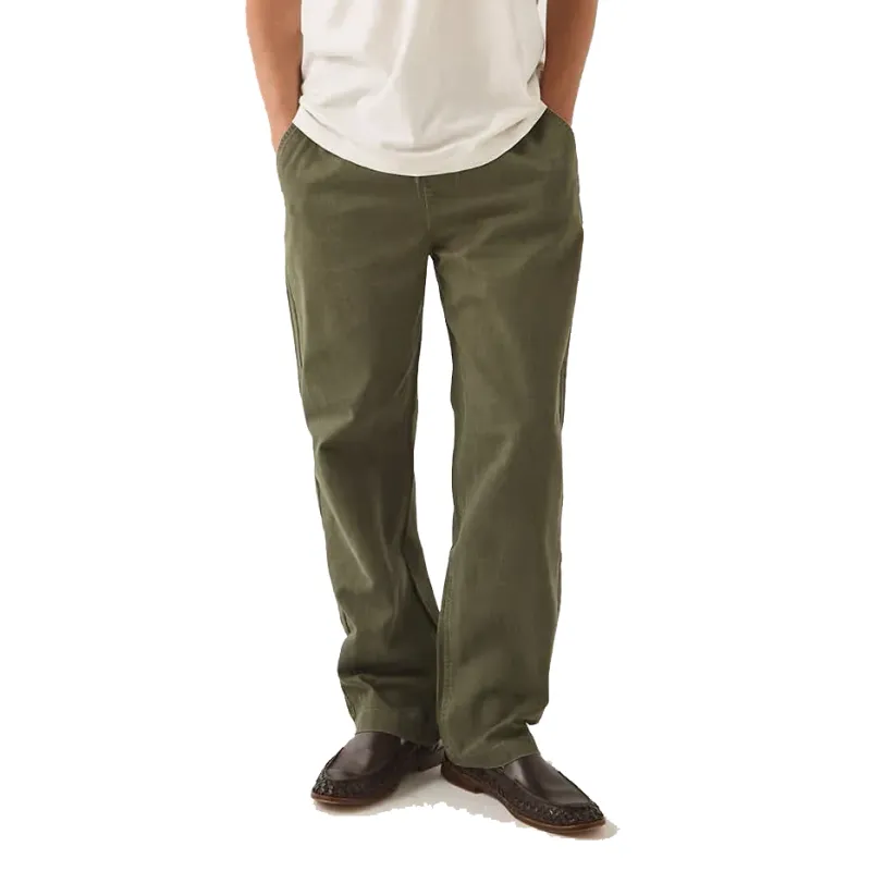 Model wearing Dark Olive Brixton Everyday E-Waist Pants with a relaxed straight-leg silhouette and brown shoes.