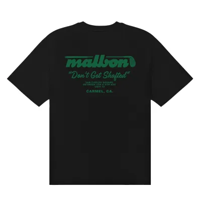 Back product view of the black Malbon Vista Repair Tee with green golf club branding and repair shop text.