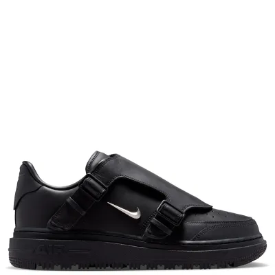 Medial view of Nike Air Force 1 LX with buckle straps and metallic silver Swoosh