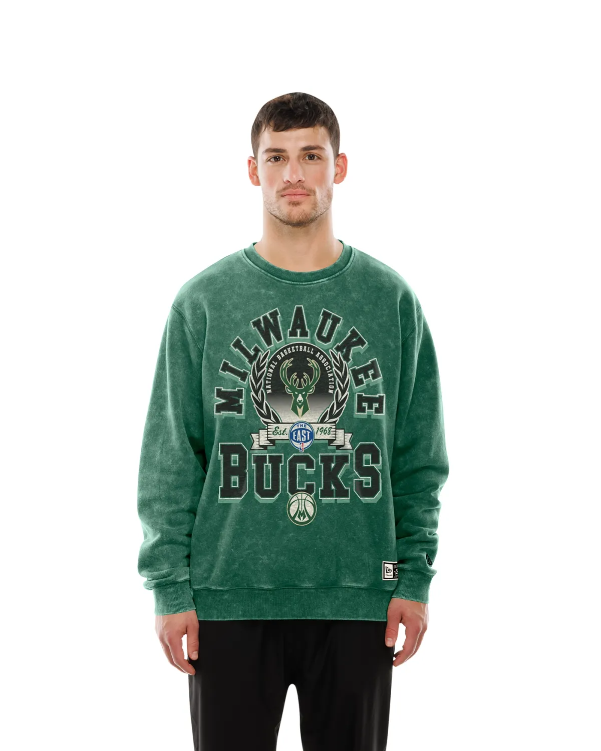 Model wearing green New Era Milwaukee Bucks Crest Mineral Wash Crewneck Sweatshirt, front view