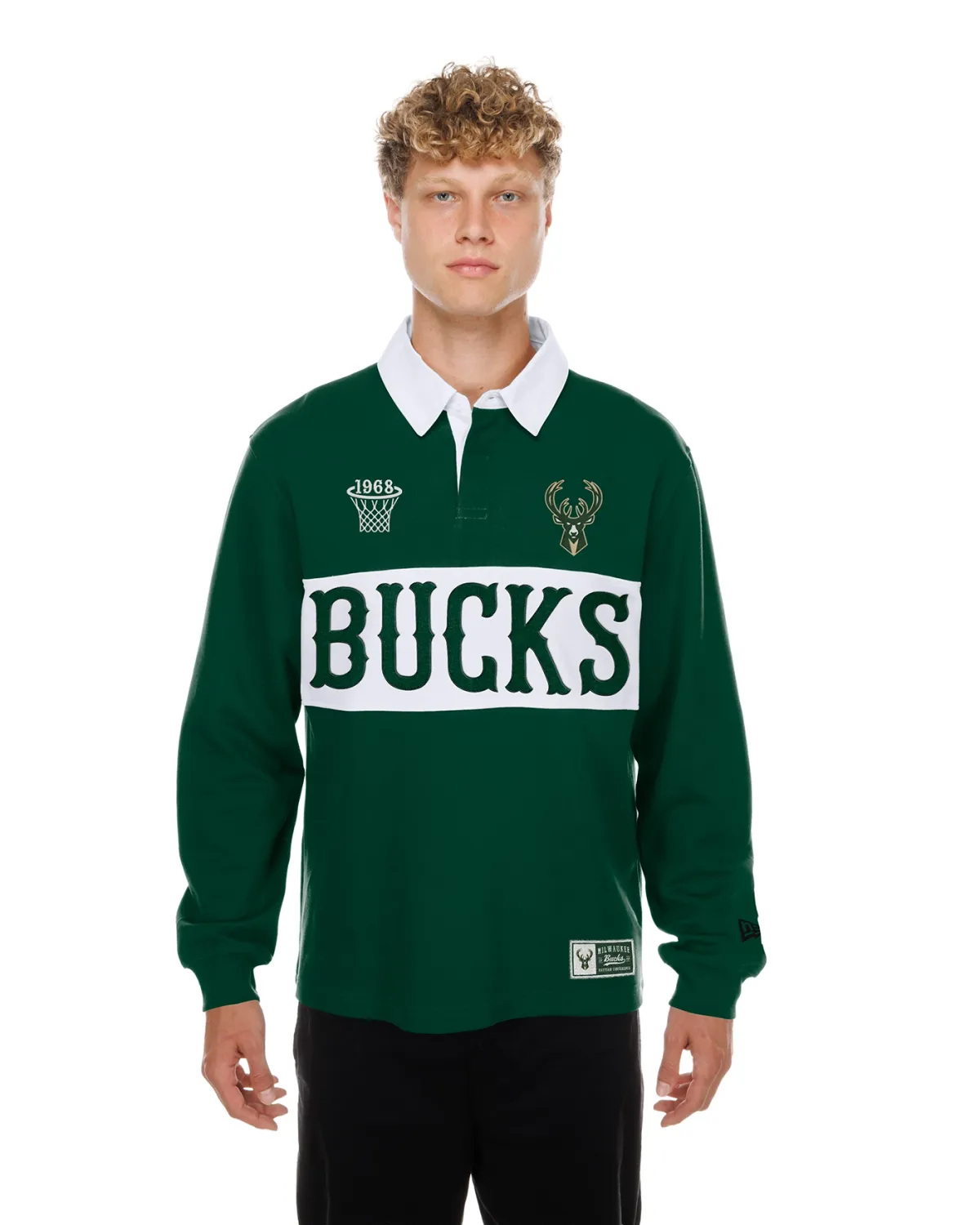 Model wearing green New Era Milwaukee Bucks Wordmark Rugby Shirt with white collar and chest panel, front view