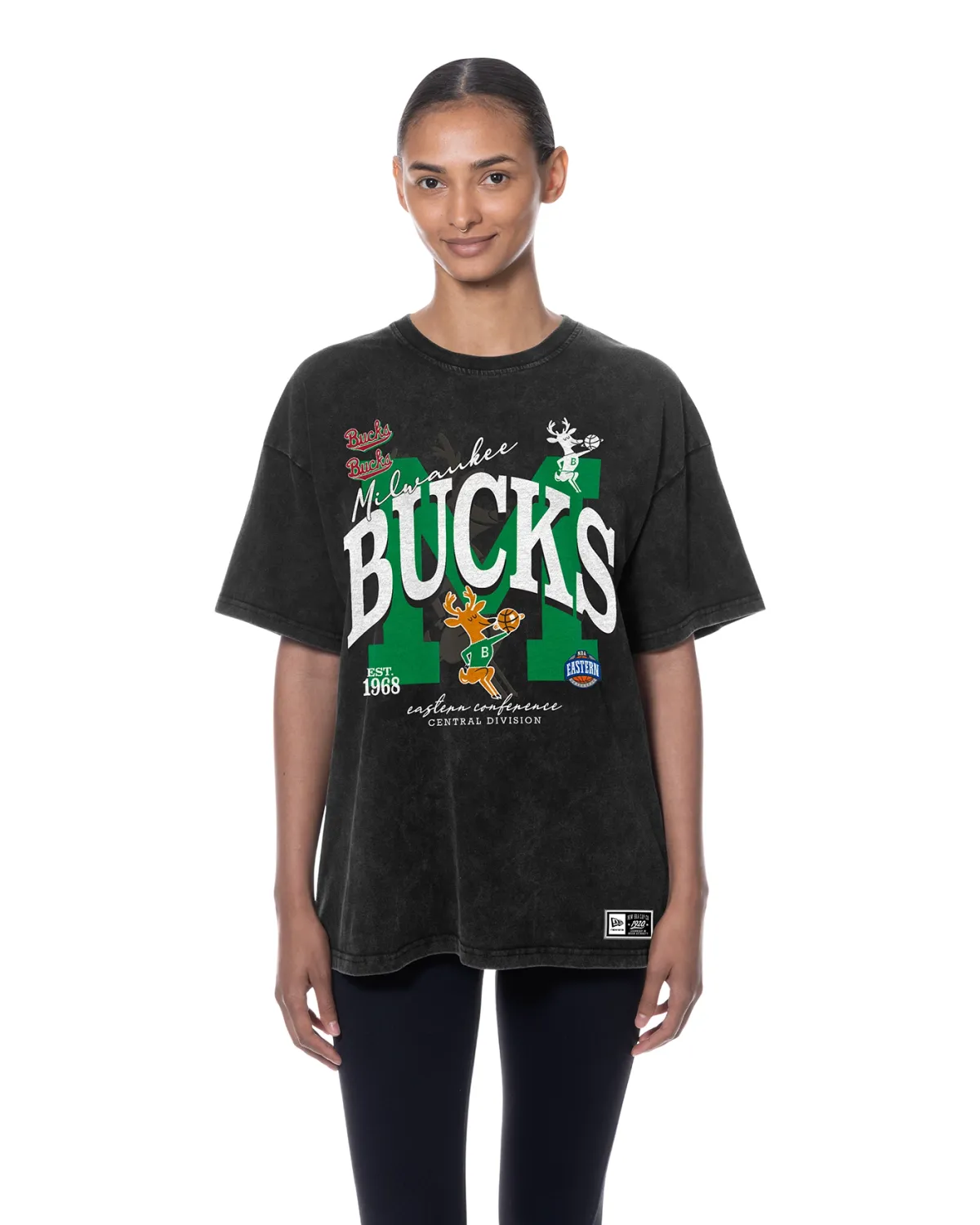 Front view of New Era Milwaukee Bucks women's oversized mineral wash tee in black with multi-logo graphics