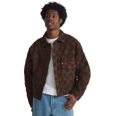 Model wearing the brown Vans Check-5 Denim Trucker Jacket open, showing its checkerboard texture and chest pockets.