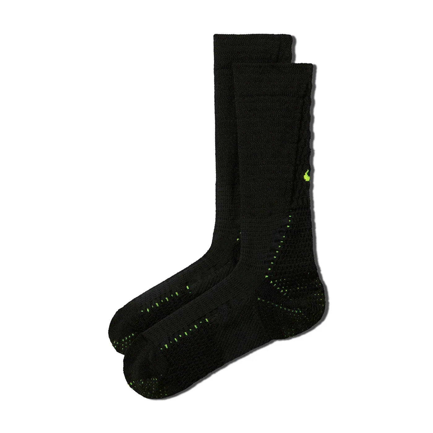 Angled product view of black Nike Unicorn crew socks with Volt Swooshes and ventilated cushioning zones.