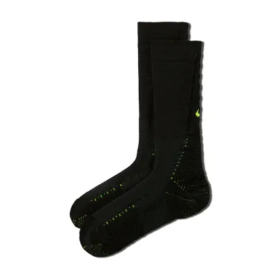 Angled product view of black Nike Unicorn crew socks with Volt Swooshes and ventilated cushioning zones.