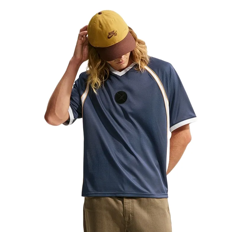 Front view of the Nike SB x Yuto Skate Jersey with V-neck, family crest and roomy fit.