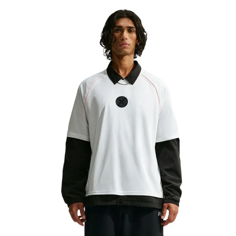 Front view of the Nike SB x Yuto Skate Jersey layered over a black collared jacket.