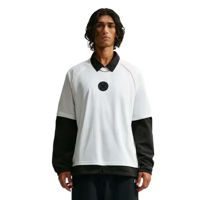 Front view of the Nike SB x Yuto Skate Jersey layered over a black collared jacket.