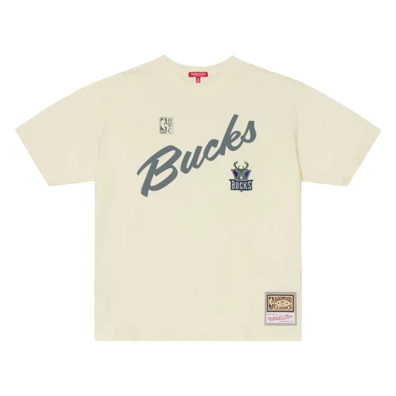 Front view of the women’s cream Bucks oversized tee with script graphic, embroidered logo and woven jock tag.