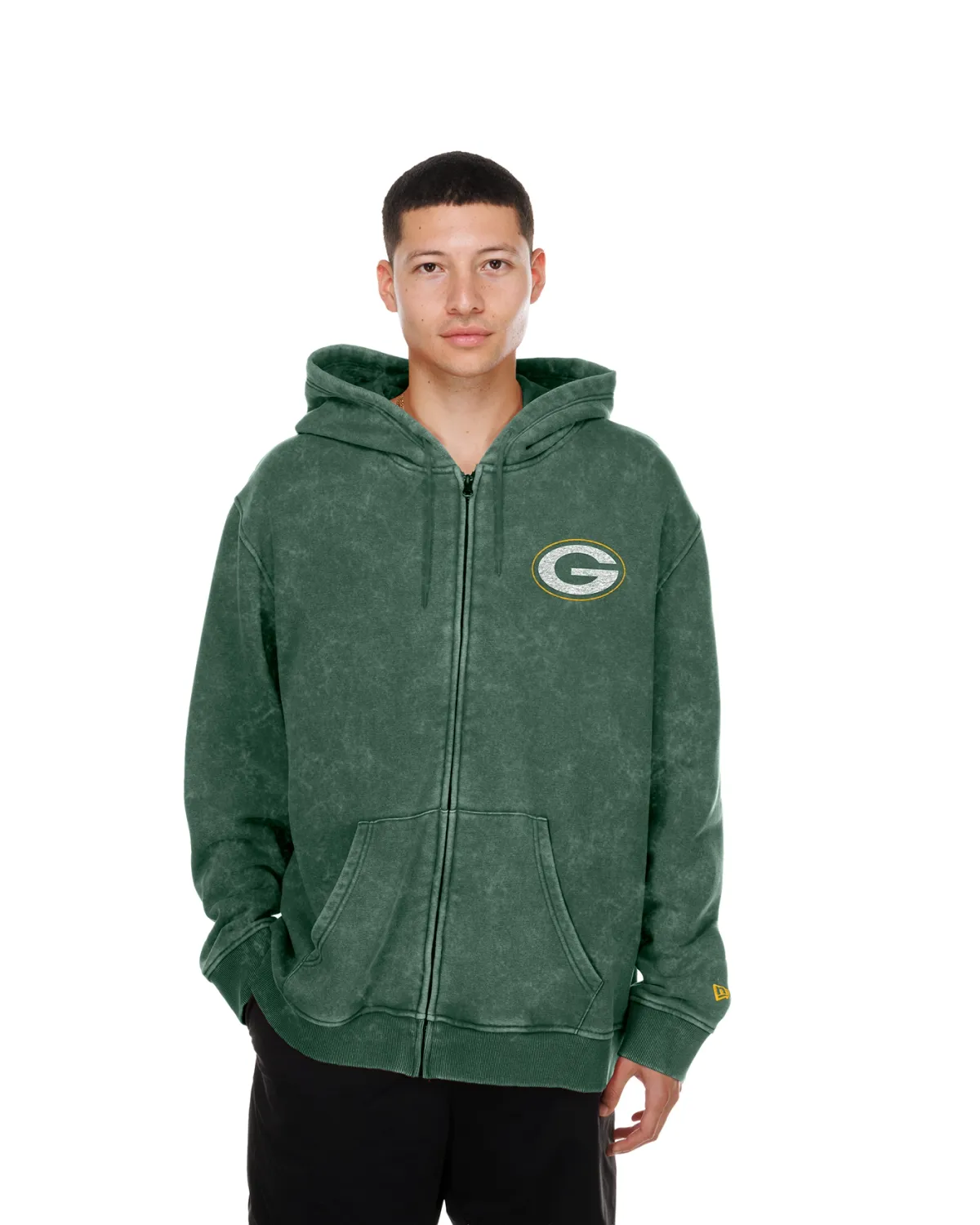 Front view of a model wearing the stone-washed green New Era Packers full-zip hoodie