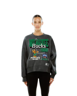Model wearing the New Era Bucks Women's Throwback Crewneck in Stone Washed Charcoal with retro front graphics.