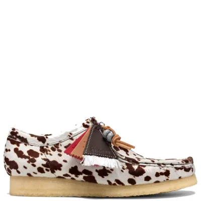 Side view of Clarks Wallabee in Brown Cow Print with a hair-on upper, collectible fobs and natural crepe sole.