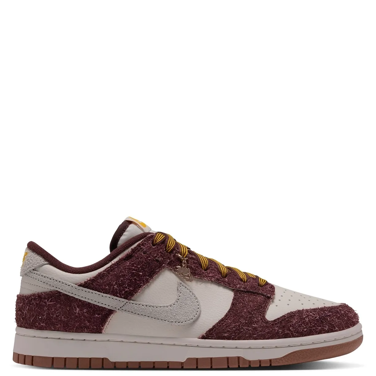 Nike Women's Dunk Low opposite side view showing a metallic lace charm and brown outsole.