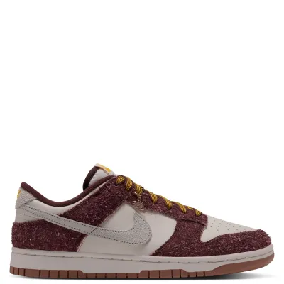 Nike Women's Dunk Low opposite side view showing a metallic lace charm and brown outsole.