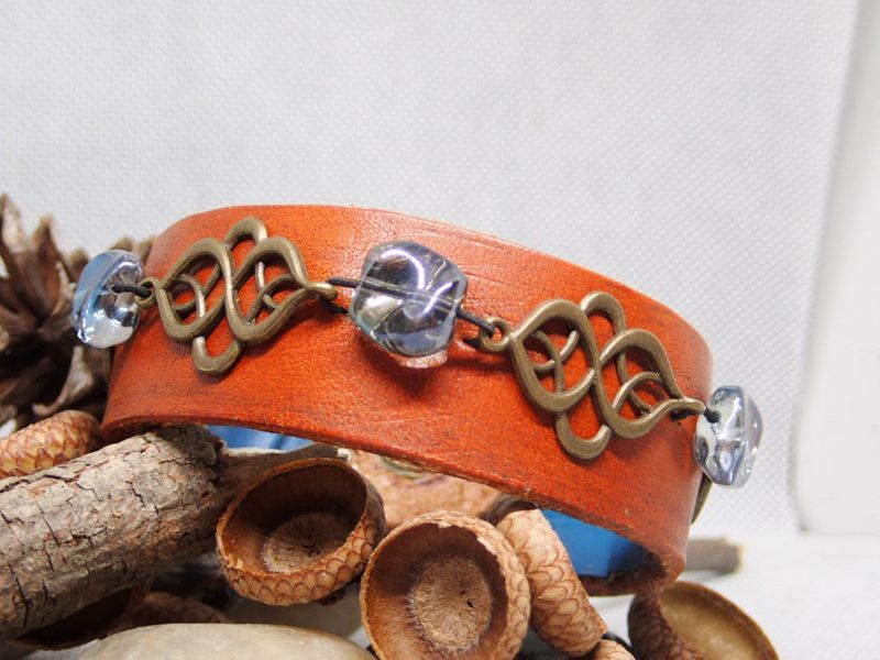 Wide leather bracelet with brass and light blue accents