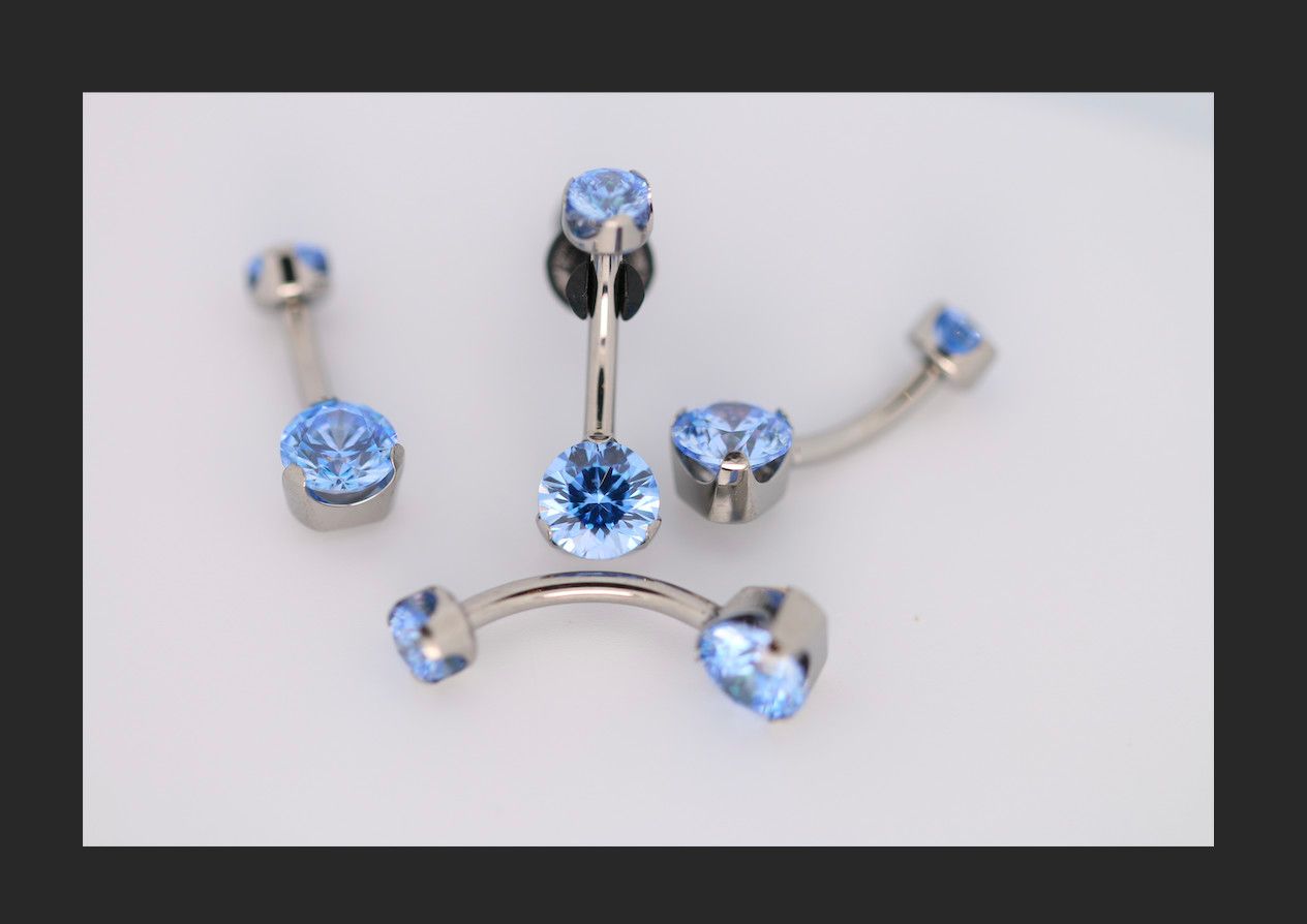 14g 1/2 brilliant cut round arctic blue prong set navel curve
