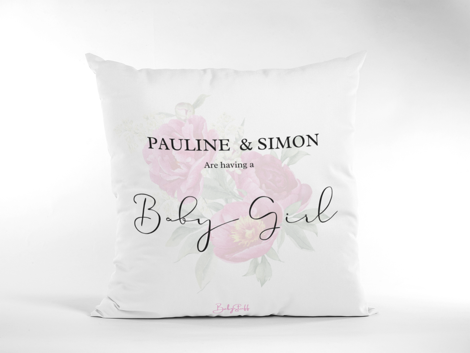 A personalised gender reveal cushion featuring soft pink floral artwork, the parents’ names, and the message &quot;We’re having a baby girl.&quot;