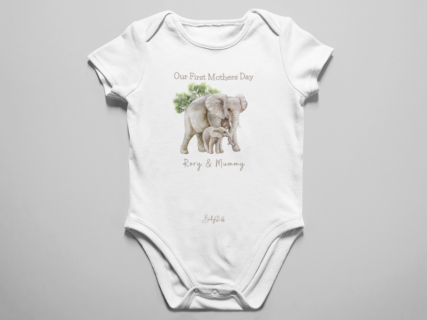 White personalised baby grow featuring an illustration of a mother and baby elephant with the text “Our First Mother’s Day”, personalised with mum and baby’s names.