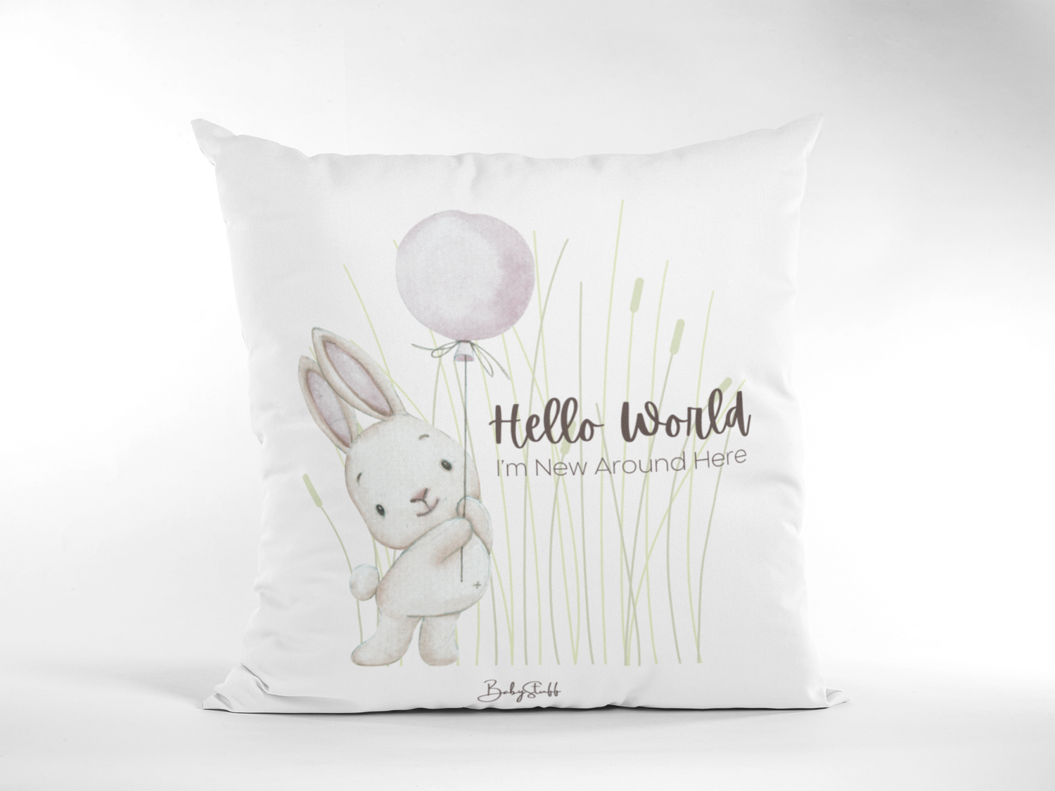Soft pastel cushion featuring a gentle rabbit holding a balloon with &quot;Hello World – I’m New Around …