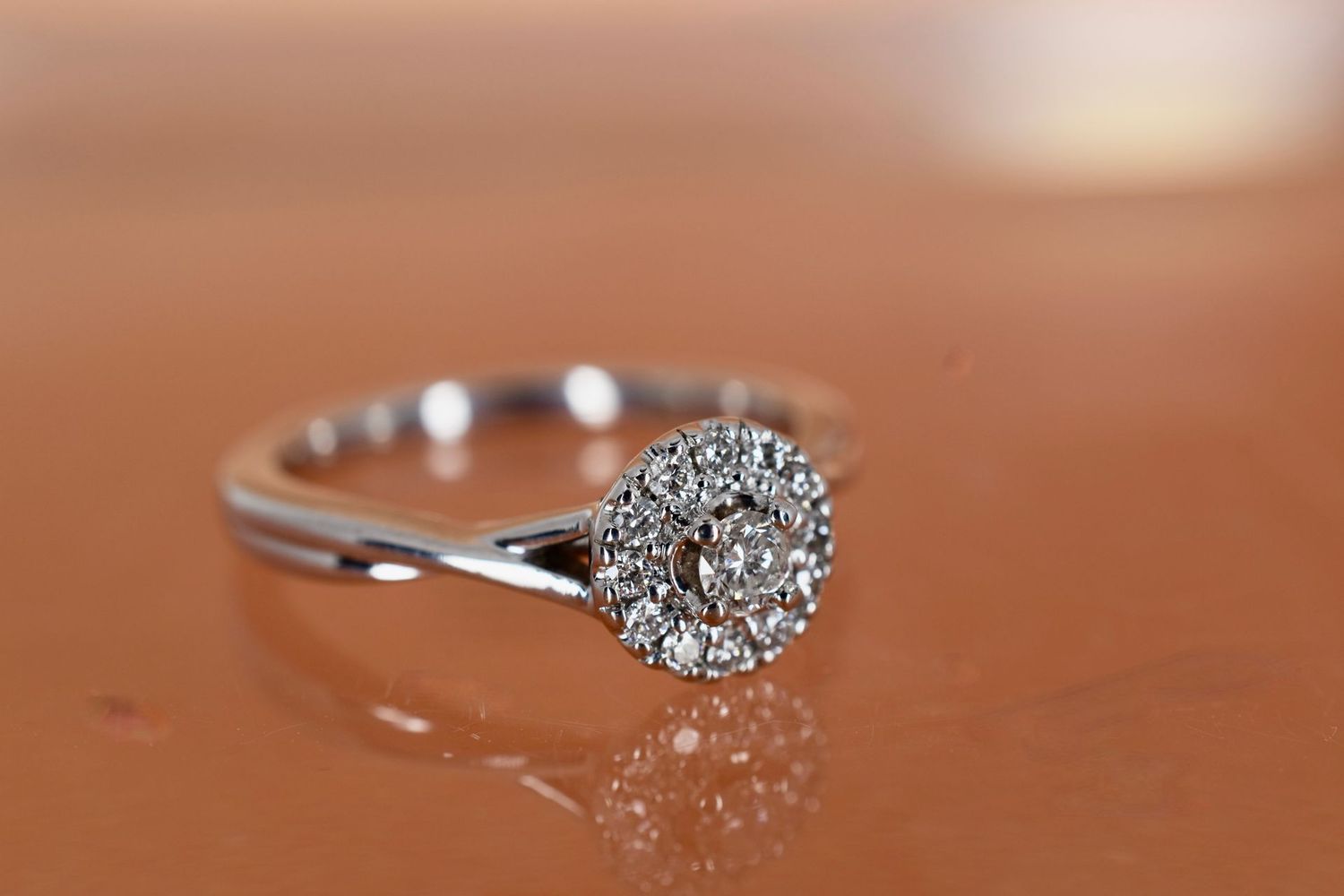 9ct White Gold Round Brilliant cut Diamond Halo Ring with Twist Shoulders