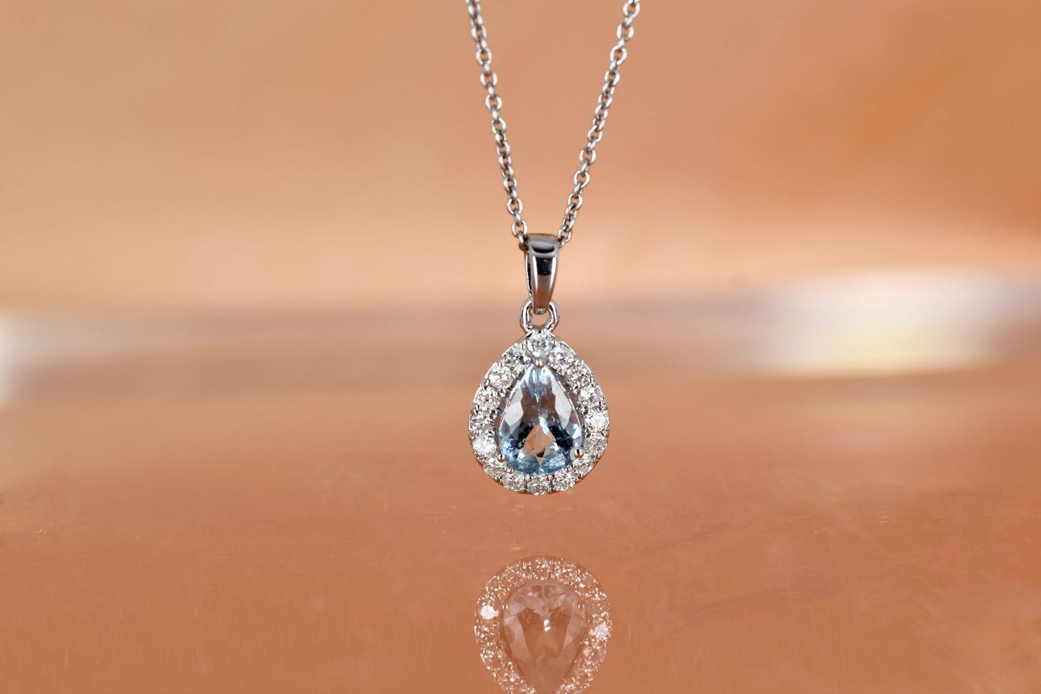 18ct White Gold Pear Cut Aquamarine and Diamond Halo pendant