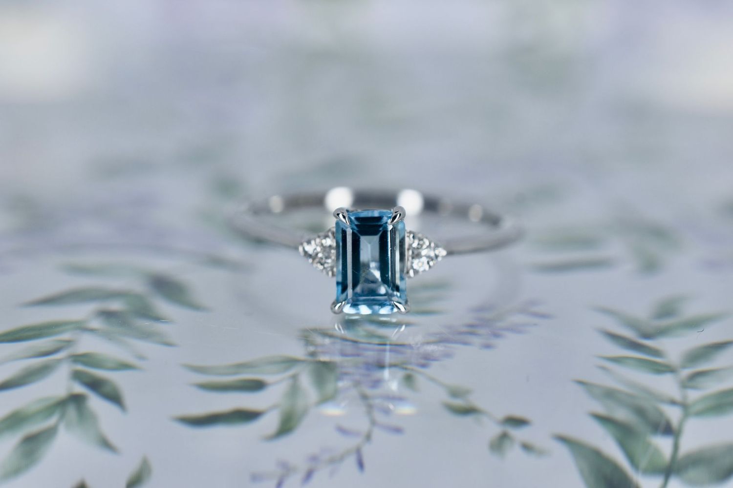 9ct White Gold Emerald cut Aquamarine and Diamond Trefoil shoulder Ring