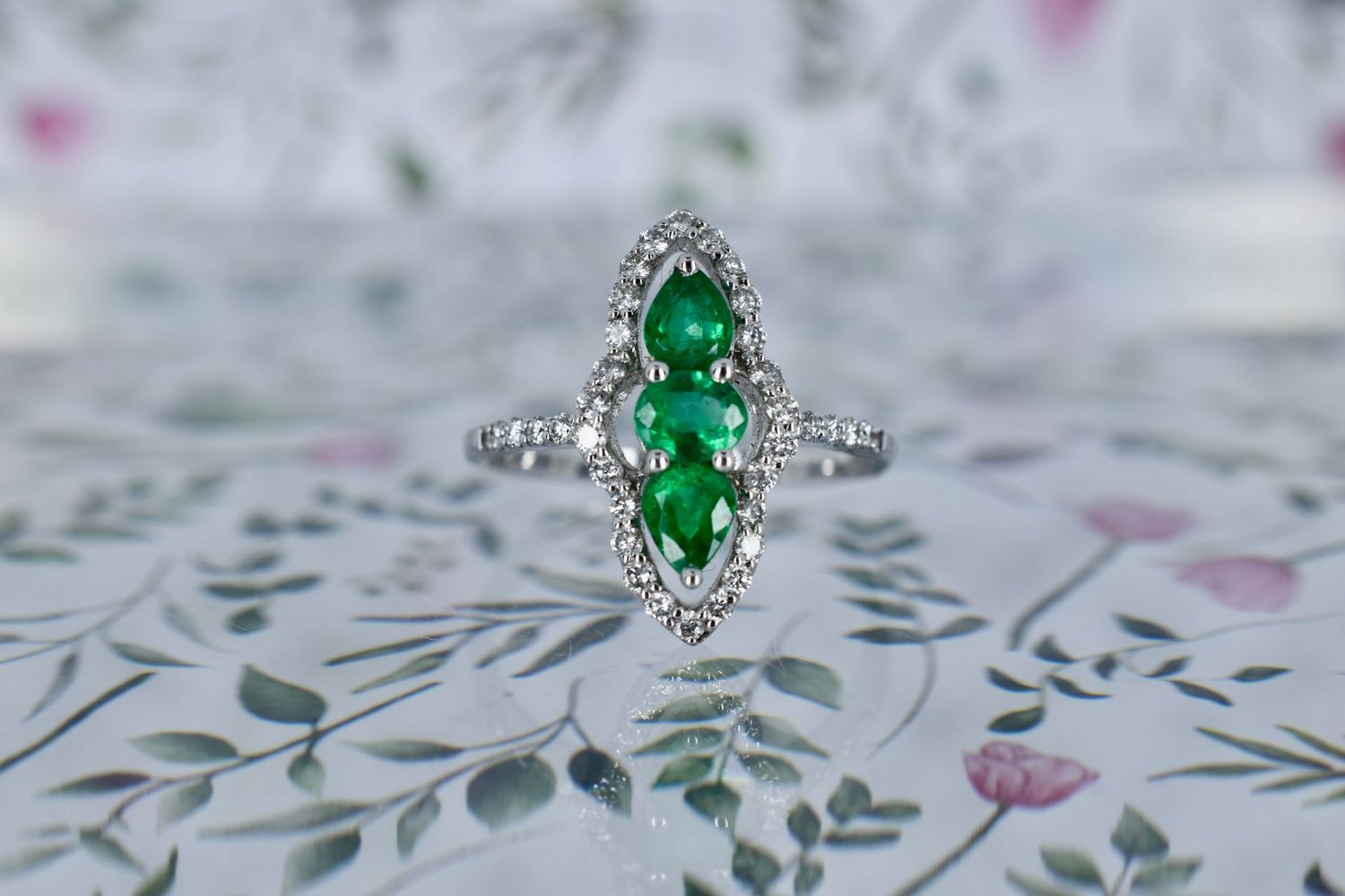 18ct White Gold Marquise shaped Emerald & Diamond Triple Halo ring