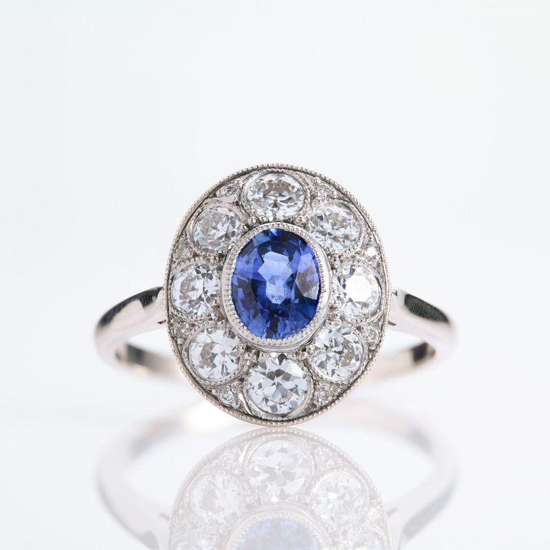 Pre-Loved 18ct White Gold Oval Cut Sapphire & Round Brilliant Cut Diamond Cluster Ring
