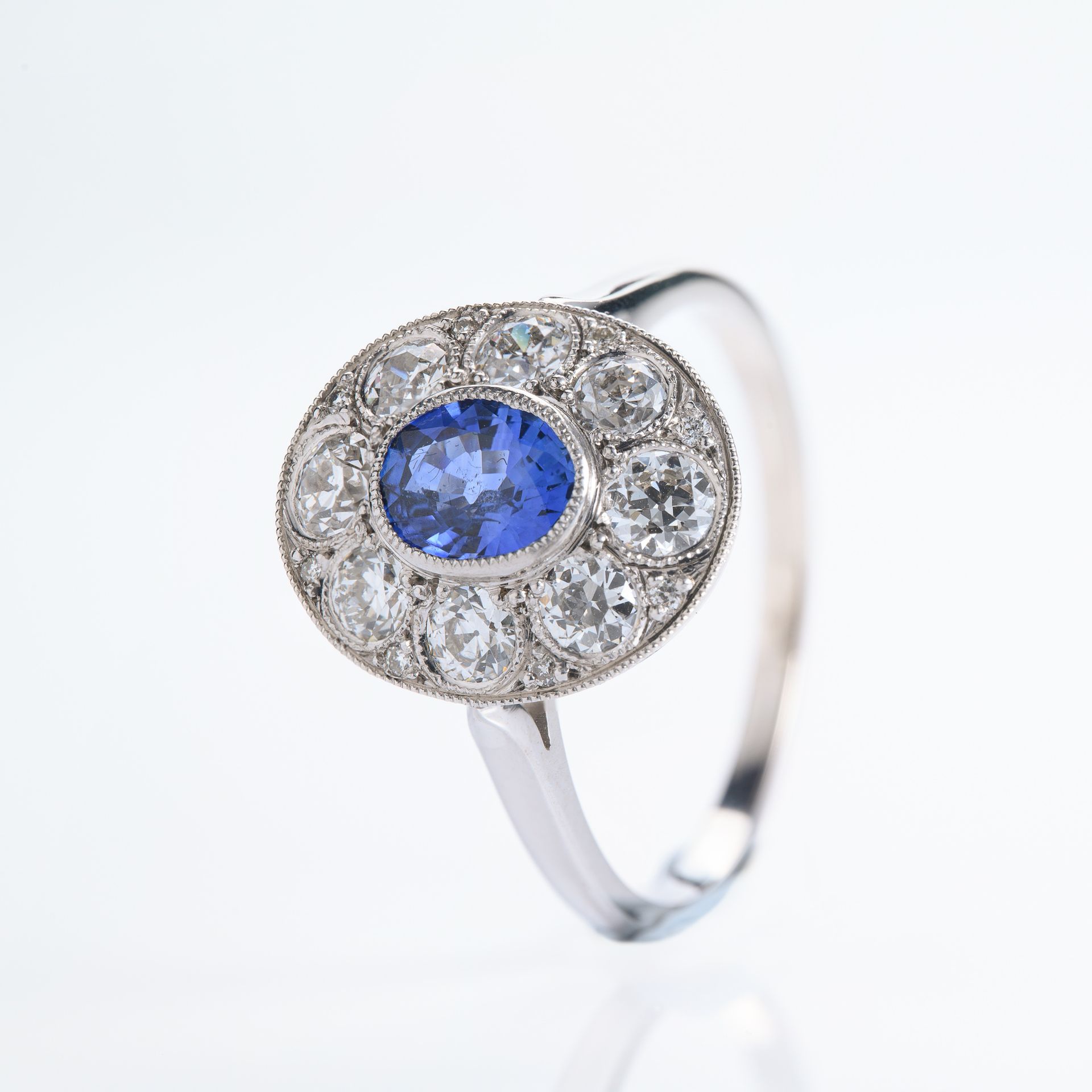 Pre-Loved 18ct White Gold Oval Cut Sapphire & Round Brilliant Cut Diamond Cluster Ring