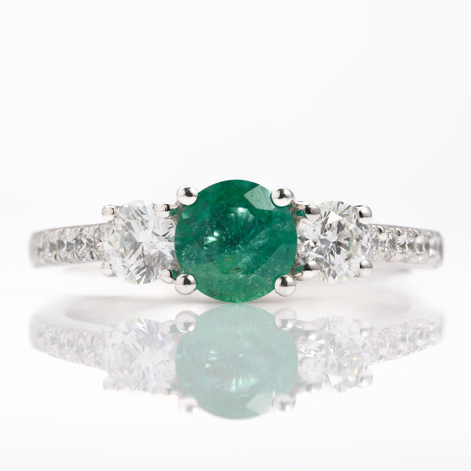 Platinum Round Cut Emerald & Round Brilliant Cut Diamond Trilogy Ring with Diamond Shoulders