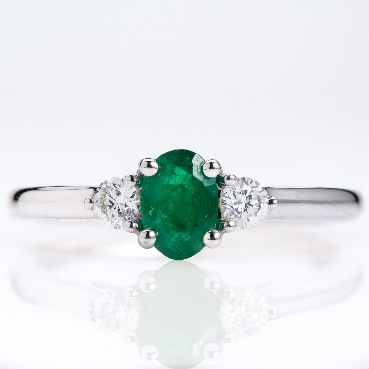 Platinum Oval Cut Emerald & Round Brilliant Cut Diamond Trilogy Ring Platinum Oval Cut Emerald & Round Brilliant Cut Diamond Trilogy Ring